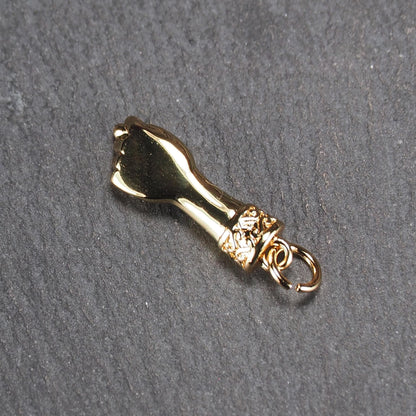 Goldfarbener Anhänger in Figa-Hand-Form mit glänzender Oberfläche, fein gravierter ornamentaler Manschette und kleiner Anhängeröse.