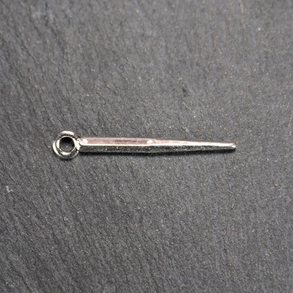 Kegelanhänger aus silberfarbenem Metall, konisch spitz zulaufend mit quadratischem Querschnitt, glatte glänzende Oberfläche und rundes Ösenauge.