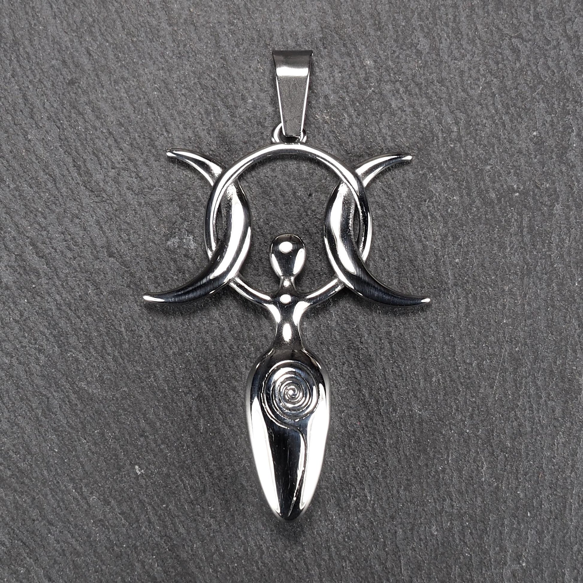 Anhänger aus poliertem silberfarbenem Edelstahl in figürlicher Form mit durchbrochenem Dreifachmond-Motiv, Spirale und Anhängerschlaufe.