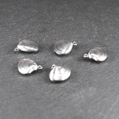 Muschelförmiger silberfarbener Anhänger mit polierter, glänzender Oberfläche, konzentrisch geriffelten Rillen und integrierter runder Öse oben.