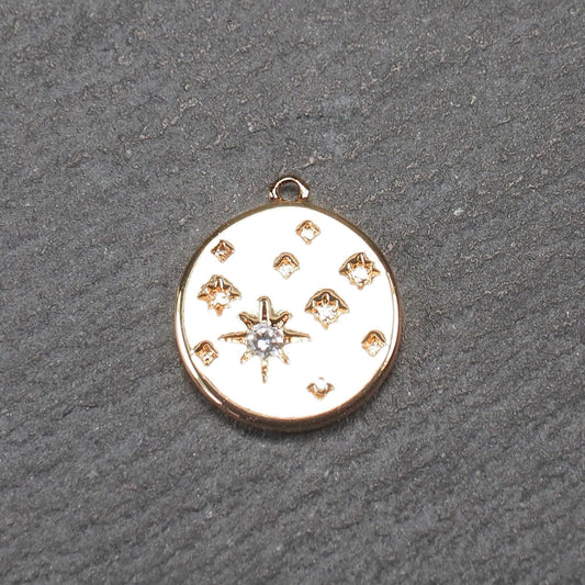 Runder goldfarbener Anhänger, glänzend glatt, mit reliefiertem Stern und mittigem klarem Stein, mehreren kleinen Sternen und oberer Öse.