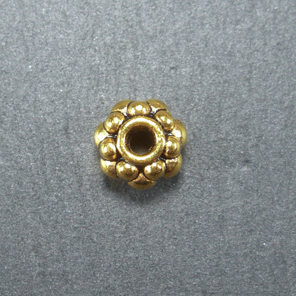 10 Spacer Perlen 7 mm, Blüten, goldfarben, 10465